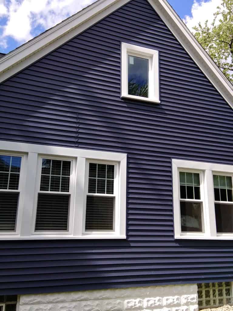 Exterior view of a blue house with new SoftLite windows