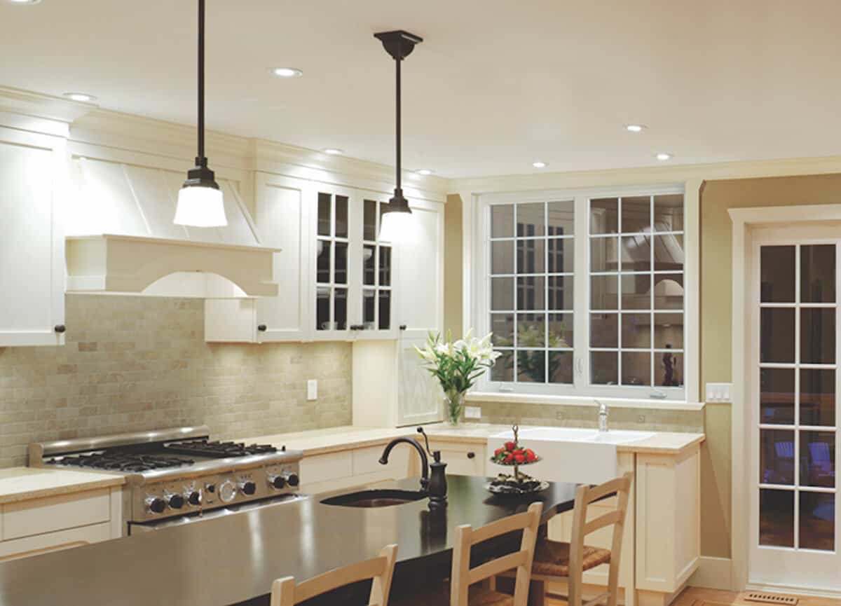 Interior view of a SoftLite beige casement window with grids in a kitchen