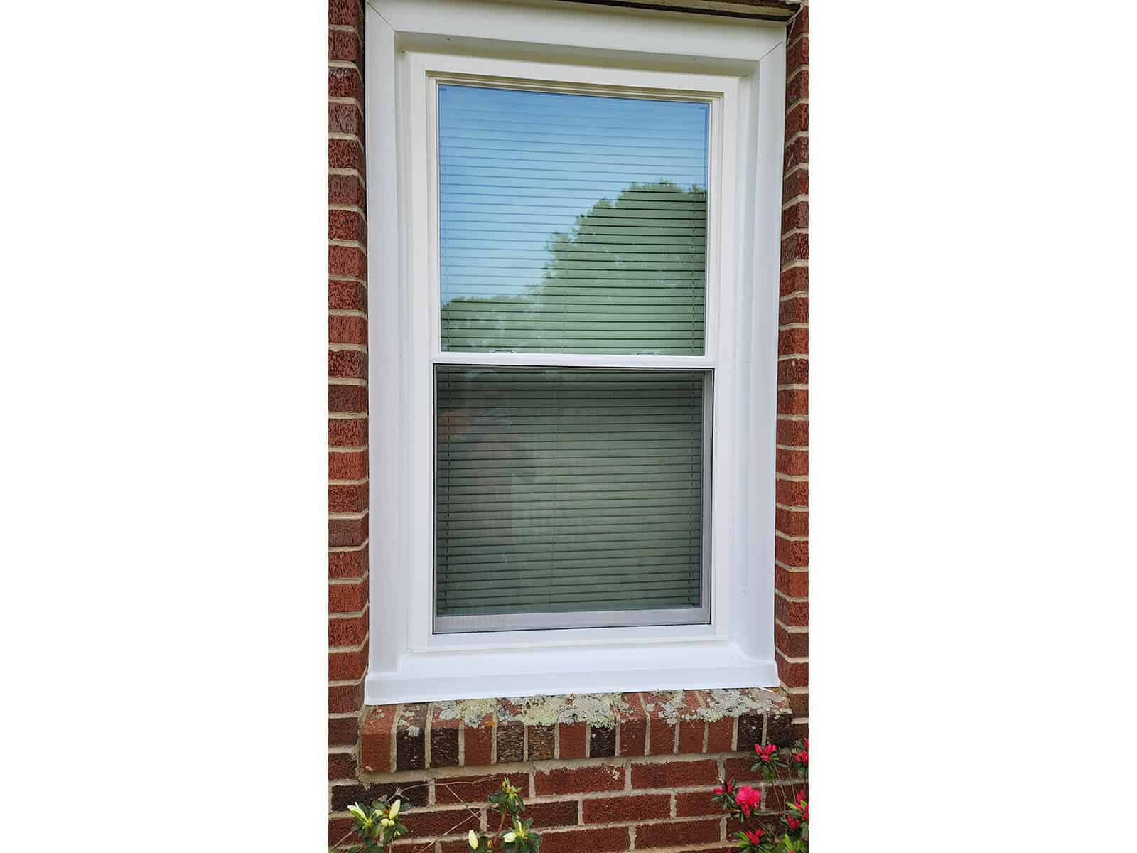 Exterior view of a brick house with a SoftLite double hung window