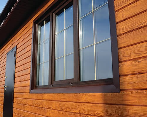 Exterior view of a slider window with brown trim