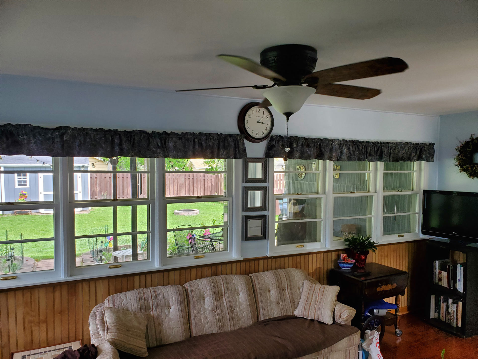 Interior view of multiple double hung windows looking into a sunroom