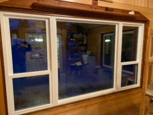 interior view of a picture window with a double hung window on either side