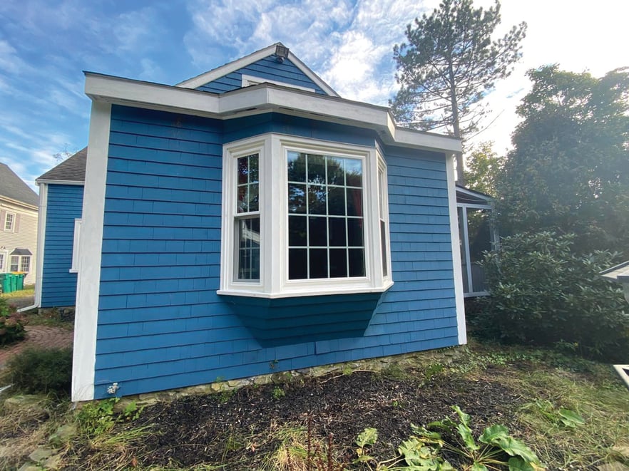 bay window in a house with blue siding