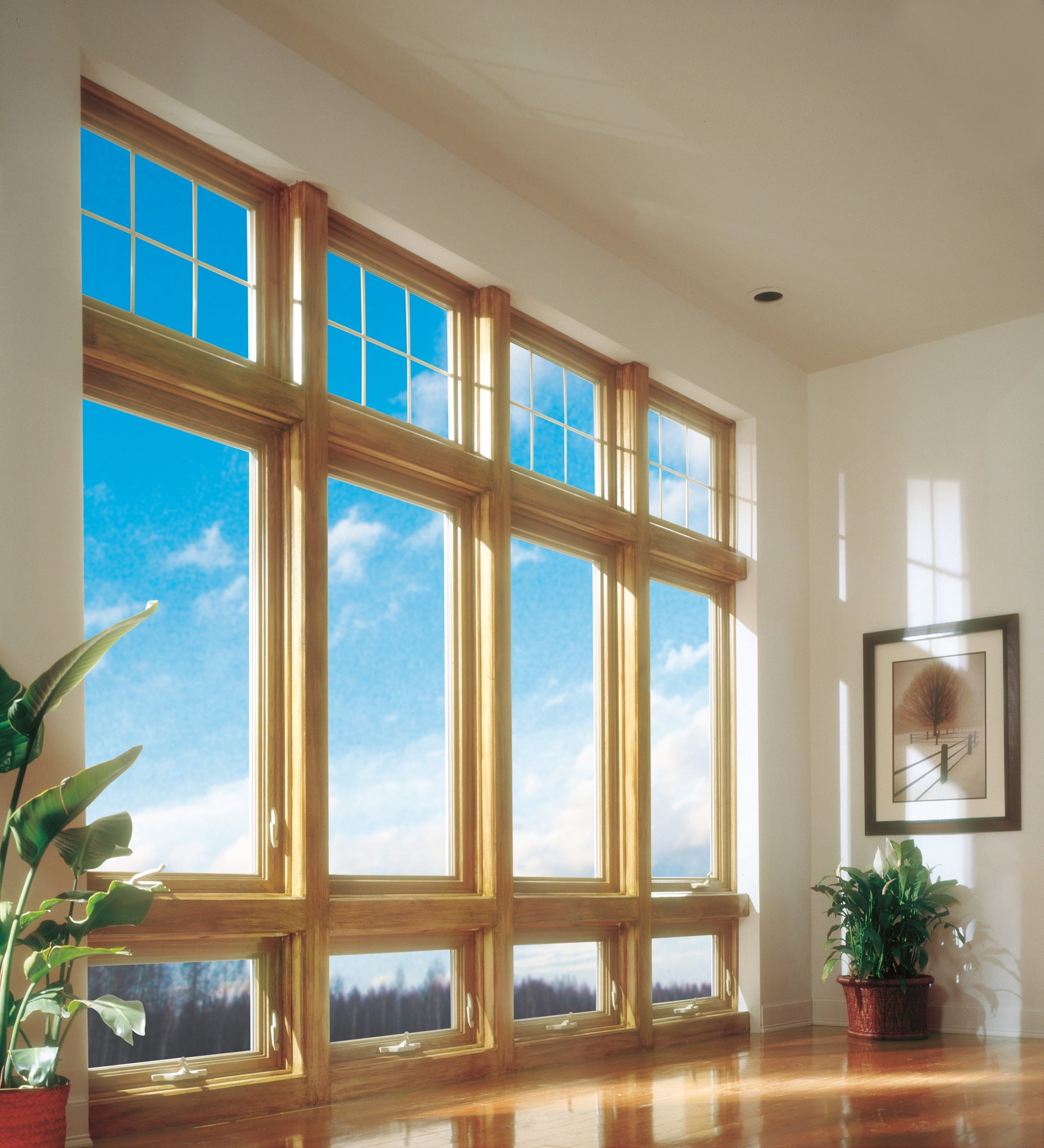 Interior view of four large casement windows with wood trim