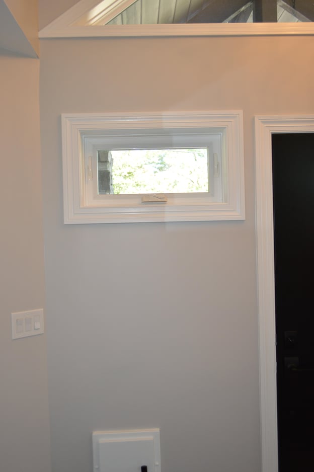 small awning window providing light and ventilation without providing visibility into the home