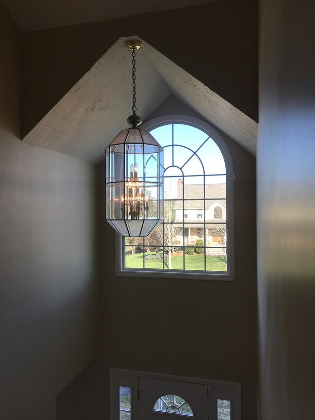 custom shaped picture window in eave of home