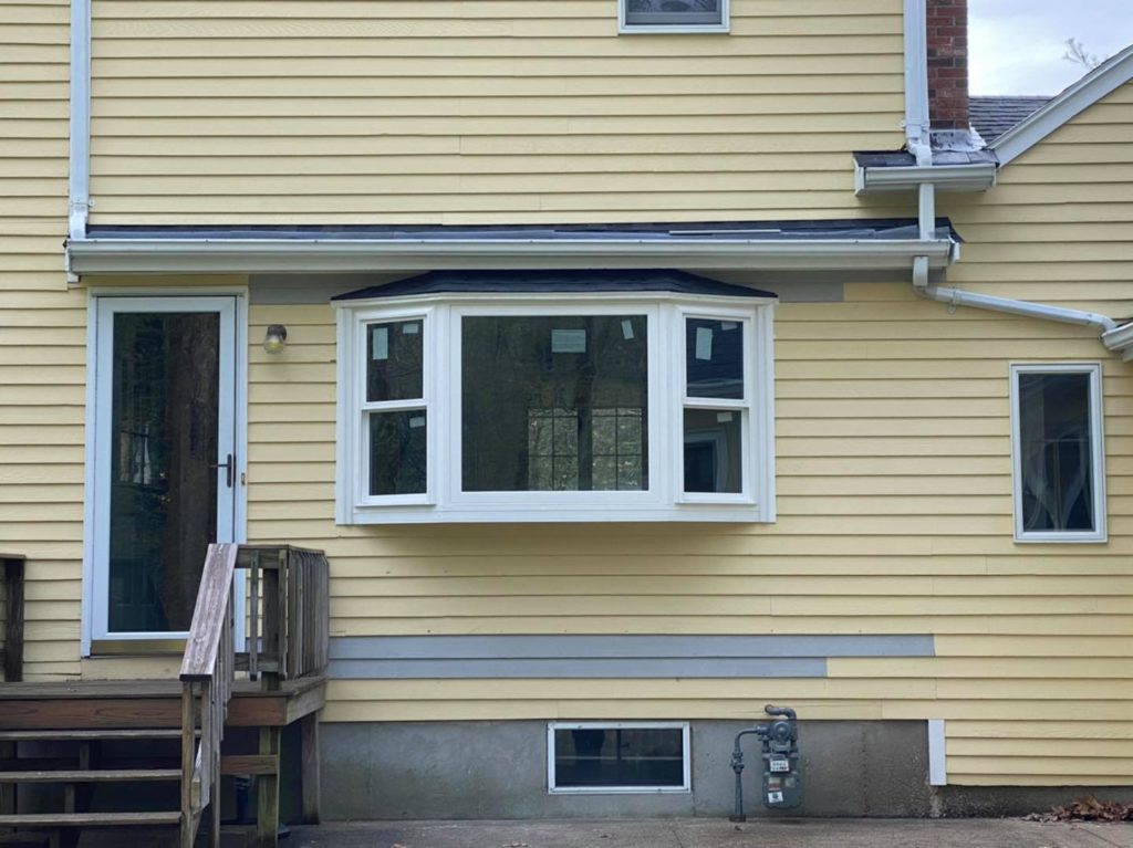 bay window in house with yellow siding