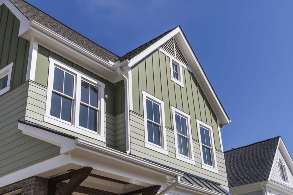 impact windows on a home with green siding