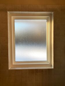 Interior view of a frosted window in a bathroom