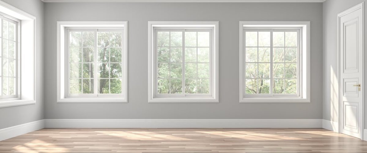 Interior of a room with four large slider windows with white grids